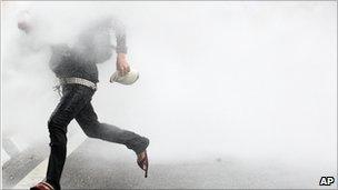 A Malaysian activist from Coalition for Clean and Fair Elections (Bersih) is sprayed by water cannon during a rally in Kuala Lumpur, Malaysia