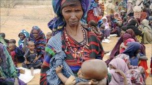 Refugees and children wait to go to a refugee camp in the Ethiopian town of Dolo Ado