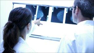 Radiographers studying a mammogram