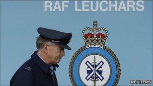 Forces person walks past RAF Leuchars sign