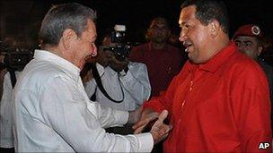 Cuba' President Raul Castro ((left) greets Venezuela's President Hugo Chavez at Havana airport