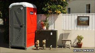 Decorated portable toilets on street corner in Sumner, Christchurch