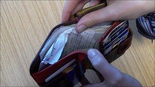 wallet with bills and credit cards