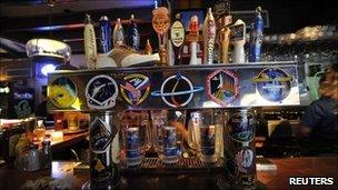 Stickers from various Nasa missions adorn the beer tap at Dogs R Us, a restaurant and bar in Titusville, Florida July 6, 2011