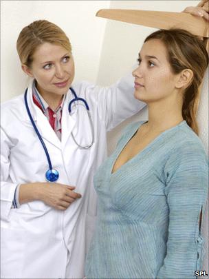 Woman having her height measured