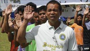 Residents and municipal employees recite their oath of allegiance to the Philippines on July 20, 2011