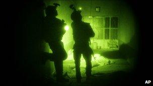 US Special Operations forces search a home during a joint operation with Afghan National Army soldiers in Afghanistan's Farah province