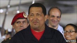 Hugo Chavez (C) gestures after his arrival from Cuba, at Simon Bolivar International Airport in Caracas July 23, 2011.