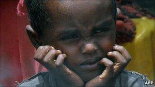 Displaced Somali boy waits for food aid at a camp in Mogadishu - 24 July