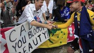 Tour de France winner Cadel Evans of Australia shakes hands with supporters after the podium ceremony in Paris, France, 24 July, 2011