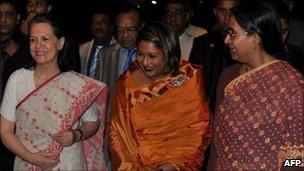 From right: Bangladeshi Foreign Minister Dipu Moni, Prime Minister Sheikh Hasina's daughter and autism expert Saima Hossain, India's Congress party president Sonia Gandhi at the Dhaka airport on 24 July 2011