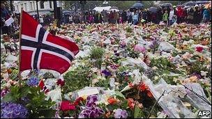 A Norwegian flag among flowers left by people in memory of the victims killed in twin terror attacks on 22 July