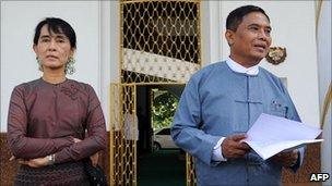 Aung San Suu Kyi (L) and Myanmar Labour Minister Aung Kyi speak to the media after talks in Rangoon (25 July)
