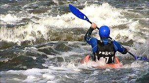 Canoeist in white water at the National Watersports Centre, Holme Pierrepont, Nottingham
