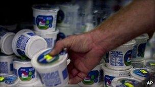 Man reaching for cottage cheese carton