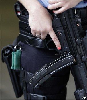 An armed Norwegian policewoman stands guard in Oslo, 25 July