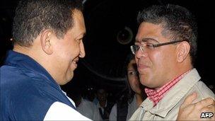 Venezuelan President Hugo Chavez (L) is welcomed by vice-president Elias Jaua Milano (R) on his arrival in Caracas after cancer surgery (4 July)