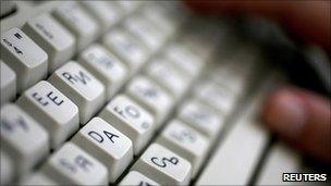 An employee types on a computer keyboard with both Latin and Cyrillic letters in Sofia in this June 2008 file photo