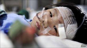 Two-year-old girl Xiang Weiyi lies in a hospital bed after she was the last survivor rescued