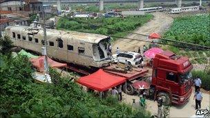 The wreckage of high-speed train carriage is carried on a truck in Shuangyu, on the outskirts of Wenzhou, Zhejiang, 26 July 2011