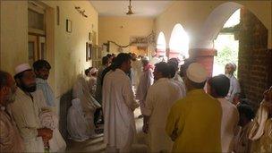 Litigants outside a court room in the Nowshera district courts