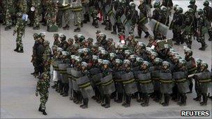 Armed police officers are deployed at a square in Kashgar (2 August)