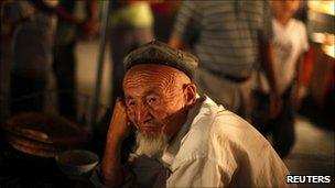 An ethnic Uighur man sits at a local market in Kashgar, Xinjiang