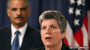 Secretary of Homeland Security Janet Napolitano speaking while Attorney General Eric Holder looks on