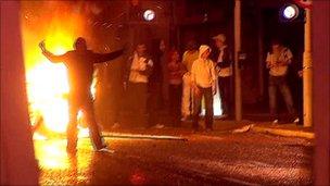 Youths rioting in front of fire