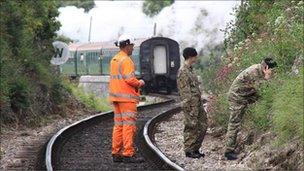 Army bomb disposal experts examining the charge