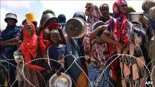 Internally displaced Somalis wait to receive food aid rations at the government-run Badbaado camp (file image from 28 July 2011)