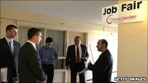 Individuals standing at a job fair