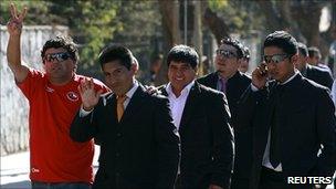 Five of the rescued Chilean miners outside the church service