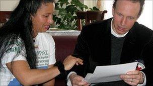 Sandra shows Guilhem Ravier of the ICRC the letters she has written requesting information