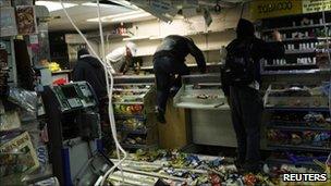 Looters in a convenience store in Hackney