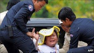 A Cambodian villager from Boeng Kak lake is detained by police during a protest in Phnom Penh on March 25, 2011