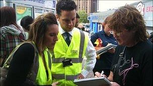 Croydon Council staff sign up people at East Croydon station to help the clean-up