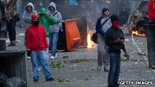 Young men standing in damaged street