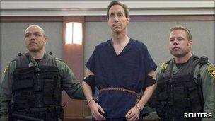 Police holding the arms of Warren Jeffs