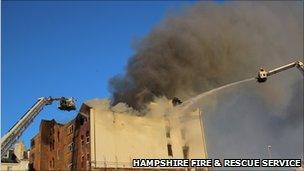 Firefighters using two aerial platforms to extinguish the blaze