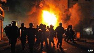 British riot police in front of a burning building in Croydon. Photo: 8 August 2011