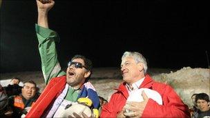 Miners Luis Urzua (left) is greeted by President Sebastian Pinera