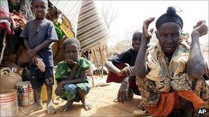 Somali refugees sit outside in an open area as there is lack of tents at the Dollo Ado refugee camp, Ethiopia, Thursday, 7 July 2011