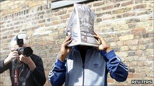 Primary school worker Alexis Bailey attempts to shield his face as he leaves court.