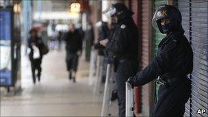 Riot police guard shops