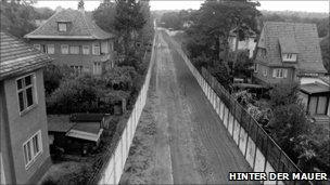 Suburban houses, divided by the wall