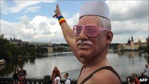 A man wearing a mask of Czech President Vaclav Klaus gestures as he takes part in the first gay pride festival in the Czech capital Prague, 13 August 2011