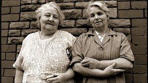 Two ladies share an orange