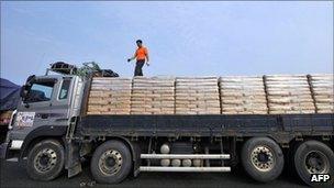 A South Korean driver checks a load of North Korea-bound flour on his truck on 26 July 2011