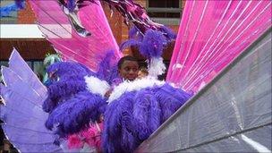 A boy in colourful costume at St Pauls Carnival in Bristol